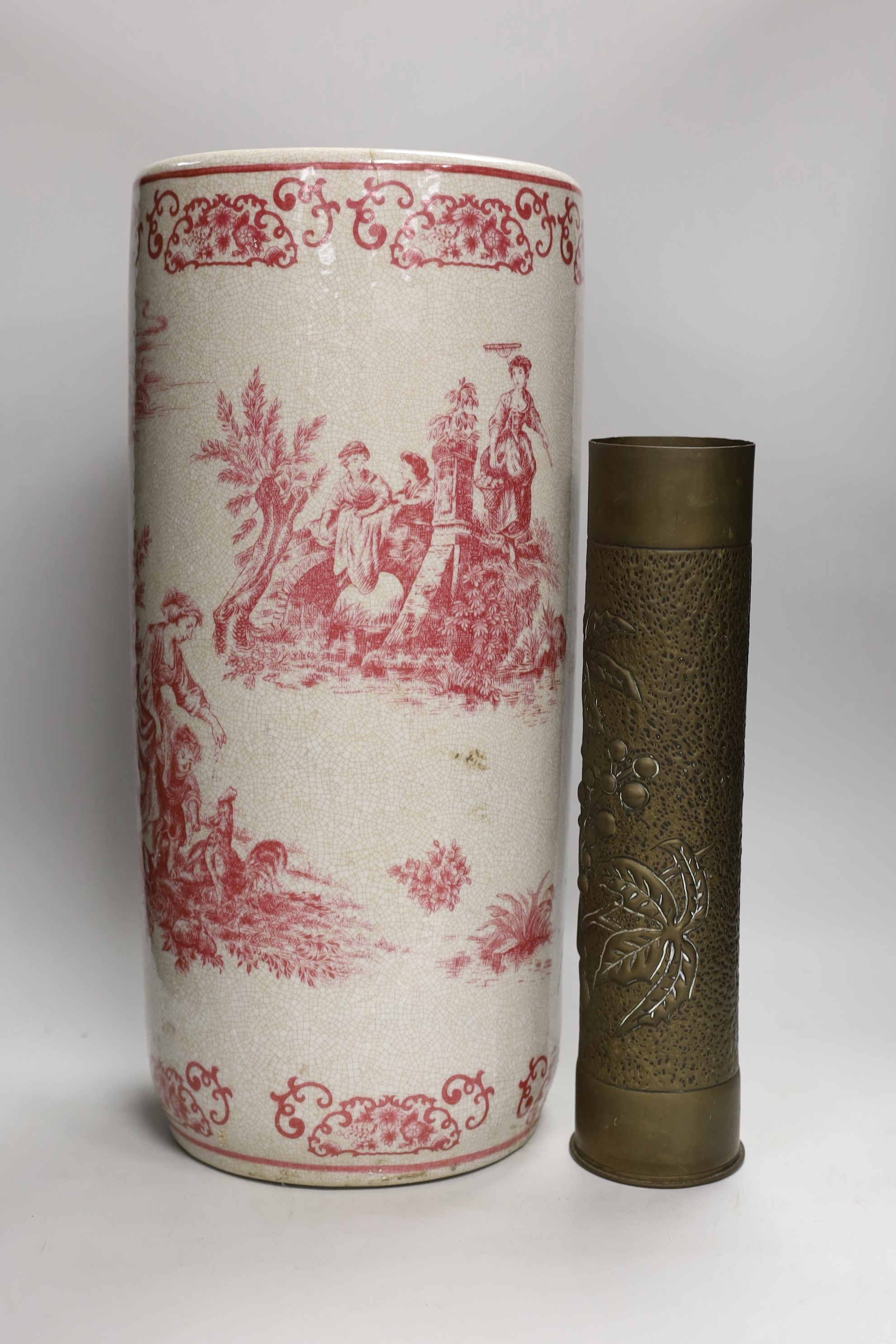 A 20th century crackle ware pottery stick stand, with toile de jouy all over design and a trench art vase, stick stand 48cms high